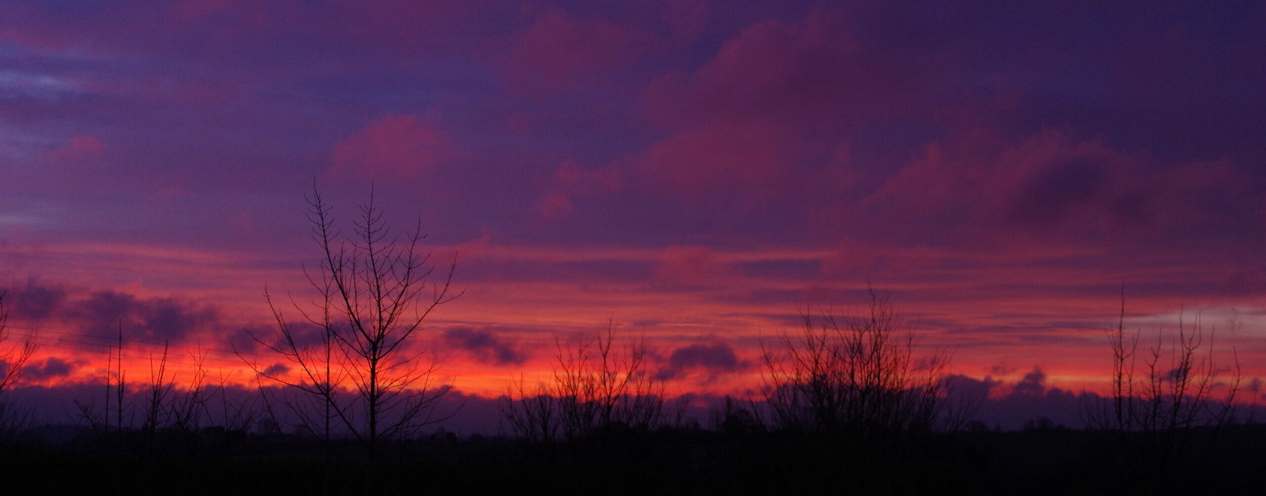 Cloudy violet and red sunrise skies