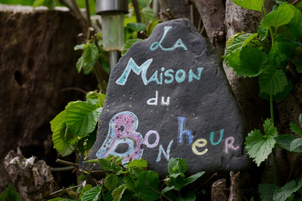 Colorful Handwritten inscription "la maison du bonheur", seen at the entrance of a property nearby SETE.